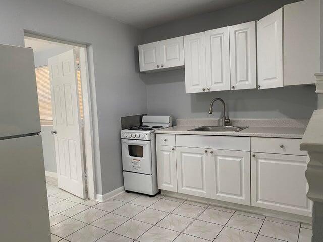 520 52nd Street West Palm Beach, FL 33407 - Photo 2 of 6 a kitchen with white cabinets and white appliances