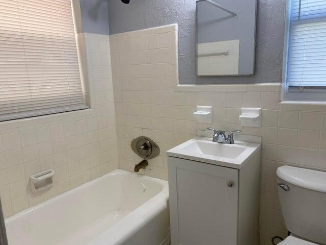 520 52nd Street West Palm Beach, FL 33407 - Photo 5 of 6 a bathroom with a sink a toilet and a bathtub