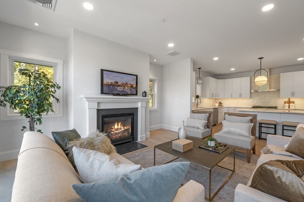 32 Pne Hl Road, Unit 32 Wenham, MA 01984 - Photo 1 of 36 a living room with furniture and a fireplace