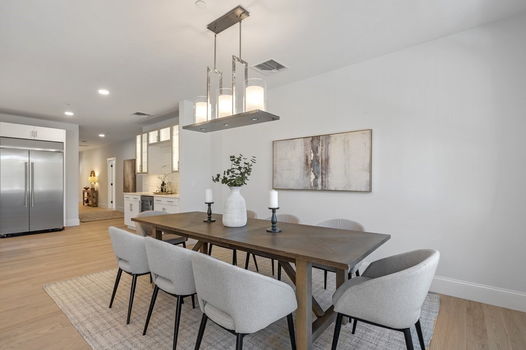 32 Pne Hl Road, Unit 32 Wenham, MA 01984 - Photo 20 of 36 a dining room with furniture a chandelier and wooden floor