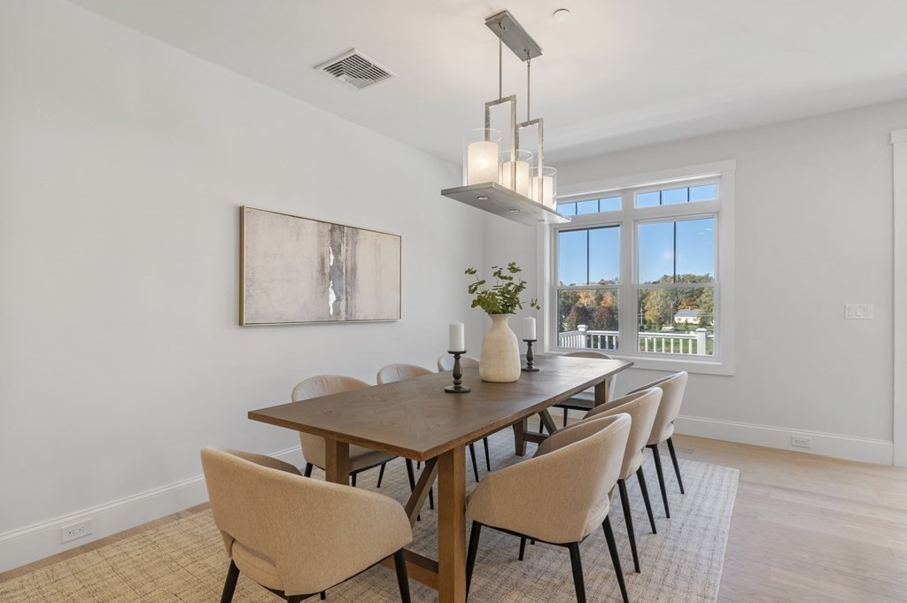 32 Pne Hl Road, Unit 32 Wenham, MA 01984 - Photo 21 of 36 a view of a dining room with furniture window and wooden floor