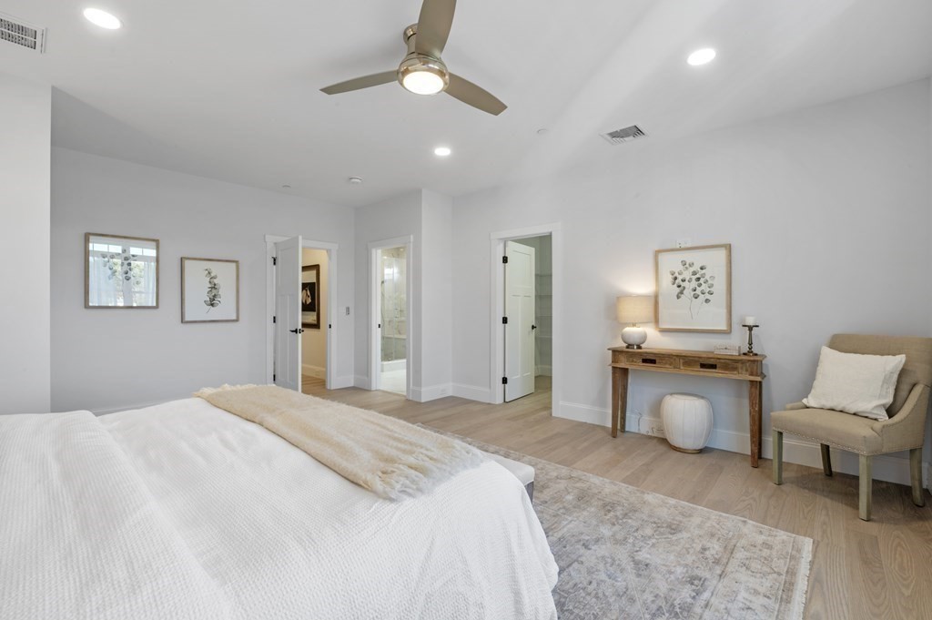 32 Pne Hl Road, Unit 32 Wenham, MA 01984 - Photo 24 of 36 a spacious bedroom with a bed and painting on the wall