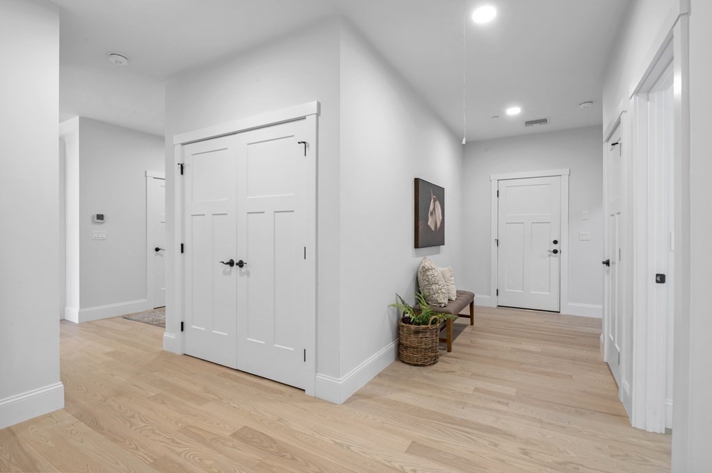 32 Pne Hl Road, Unit 32 Wenham, MA 01984 - Photo 30 of 36 a view of a hallway with wooden floor and a cabinet