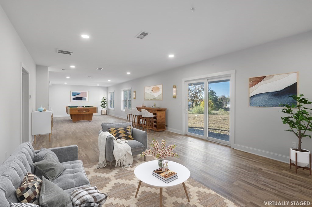 32 Pne Hl Road, Unit 32 Wenham, MA 01984 - Photo 34 of 36 a living room with furniture and a wooden floor
