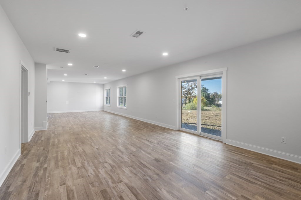 32 Pne Hl Road, Unit 32 Wenham, MA 01984 - Photo 35 of 36 a view of an empty room with wooden floor and a window