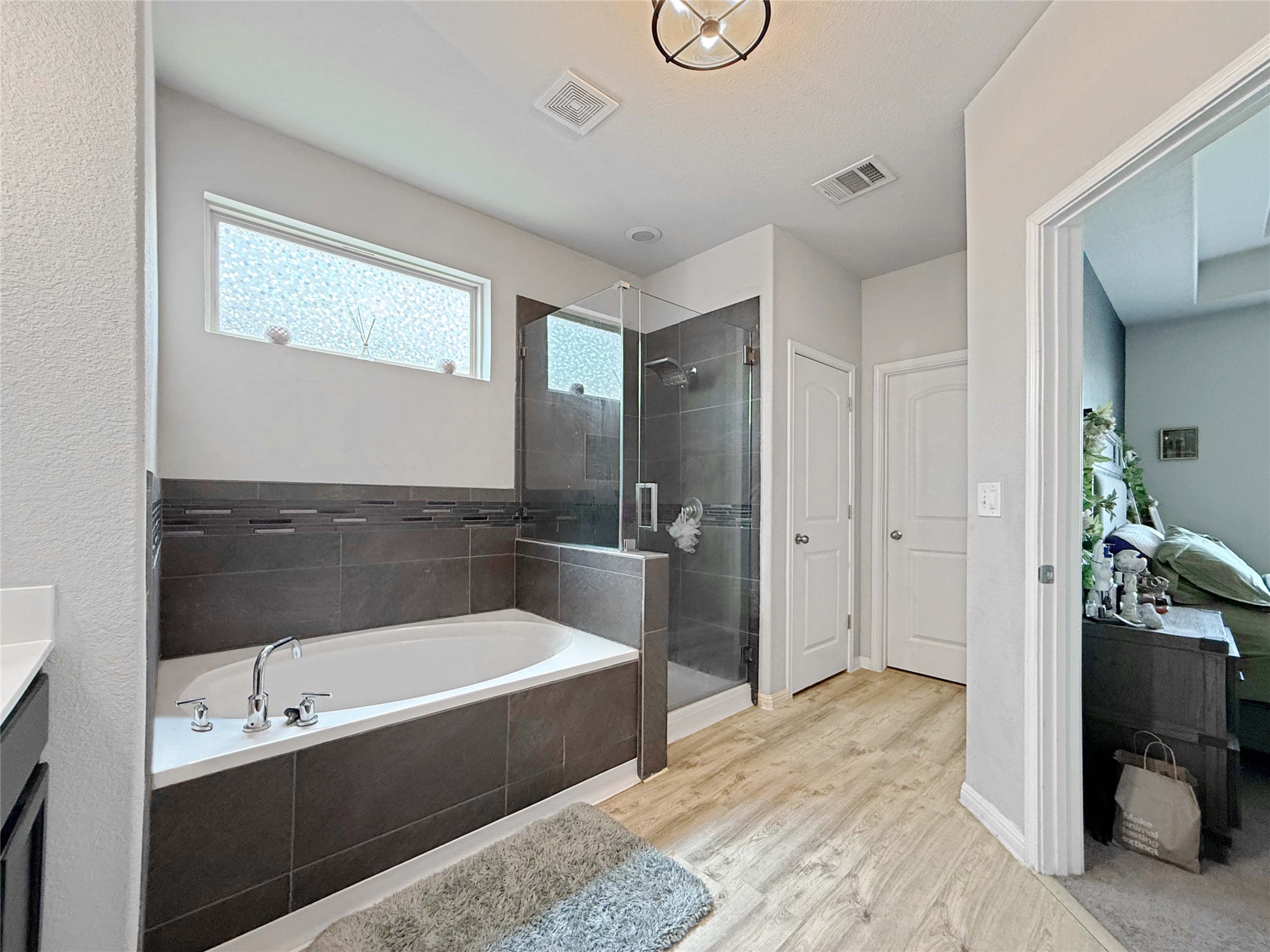 429 Rusk Bluff Avenue Leander, TX 78641 - Photo 10 of 24 Luxurious bath with an oversized soaking tub and a spacious glass-enclosed shower.