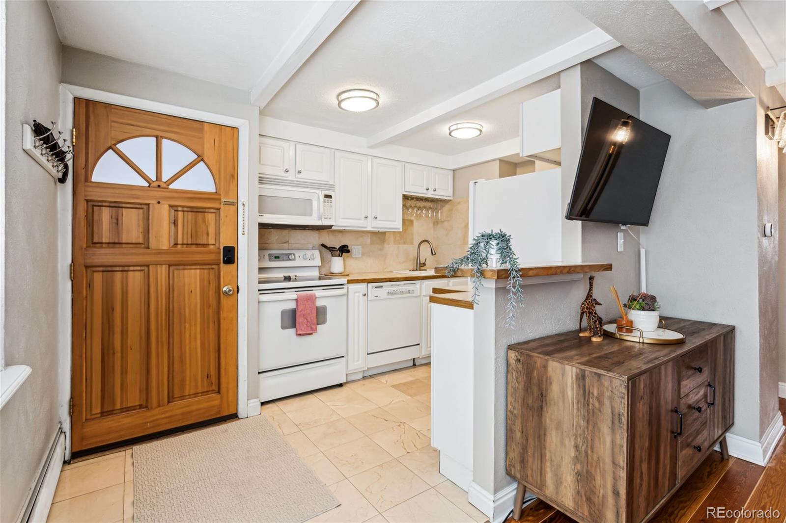 160 Jackson Street, Unit 5 Denver, CO 80206 - Photo 11 of 35 a kitchen with a sink appliances and cabinets