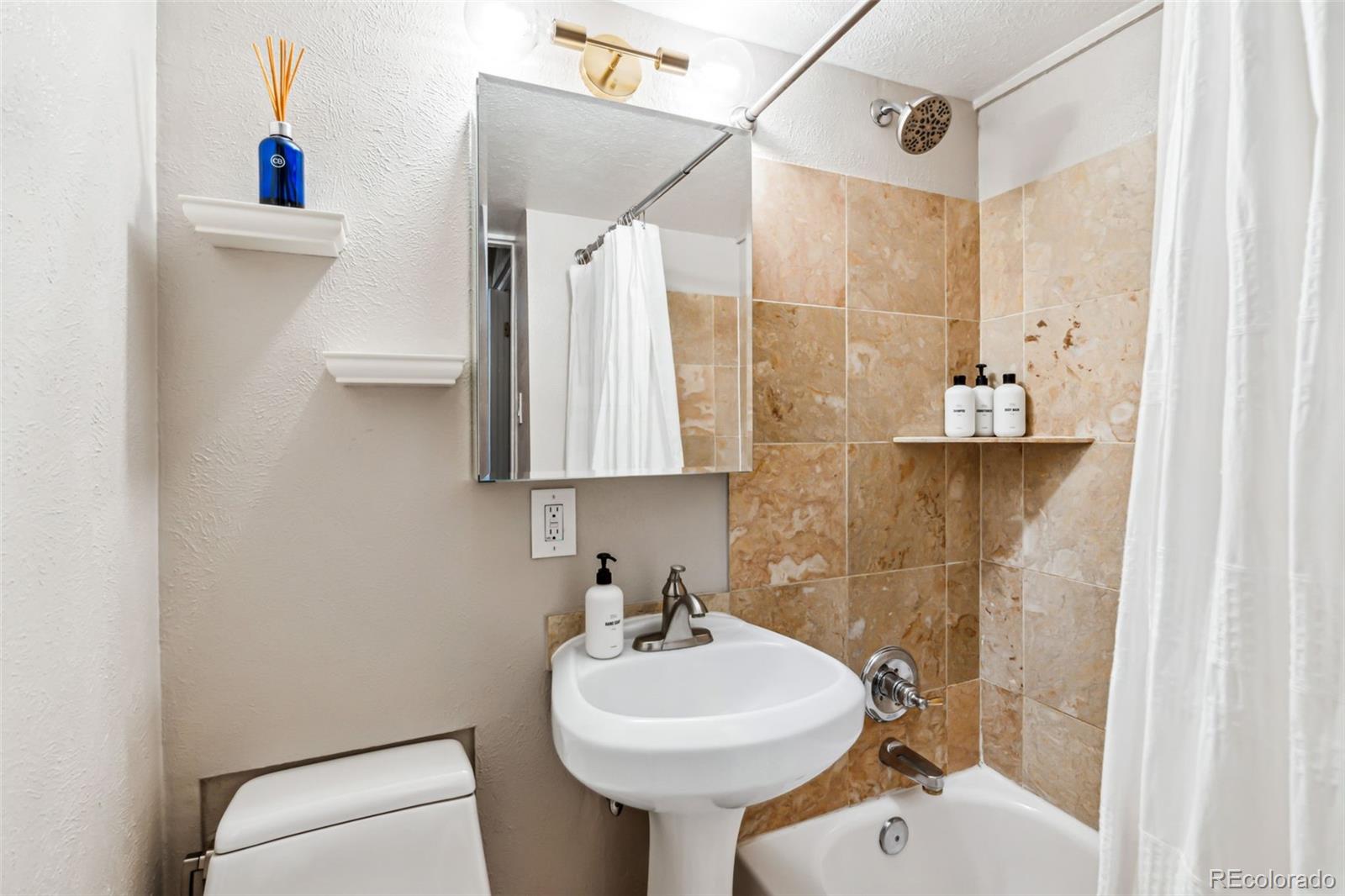 160 Jackson Street, Unit 5 Denver, CO 80206 - Photo 19 of 35 a bathroom with a sink toilet and shower