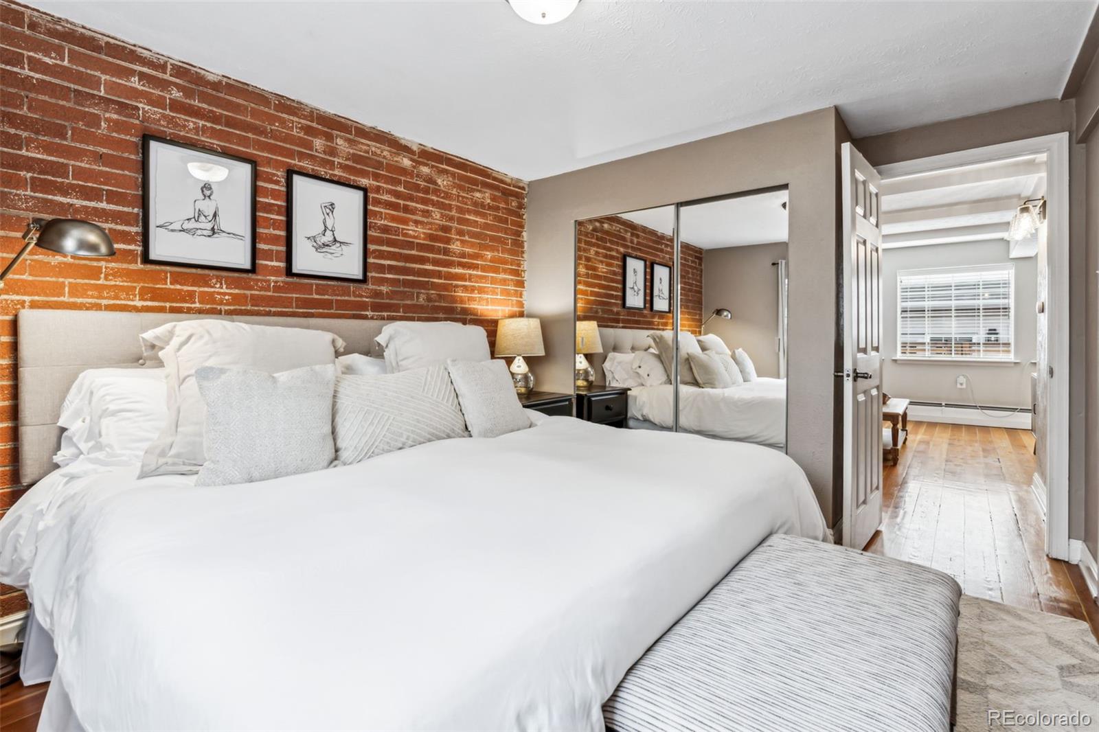 160 Jackson Street, Unit 5 Denver, CO 80206 - Photo 20 of 35 a bedroom with a bed and a night stand