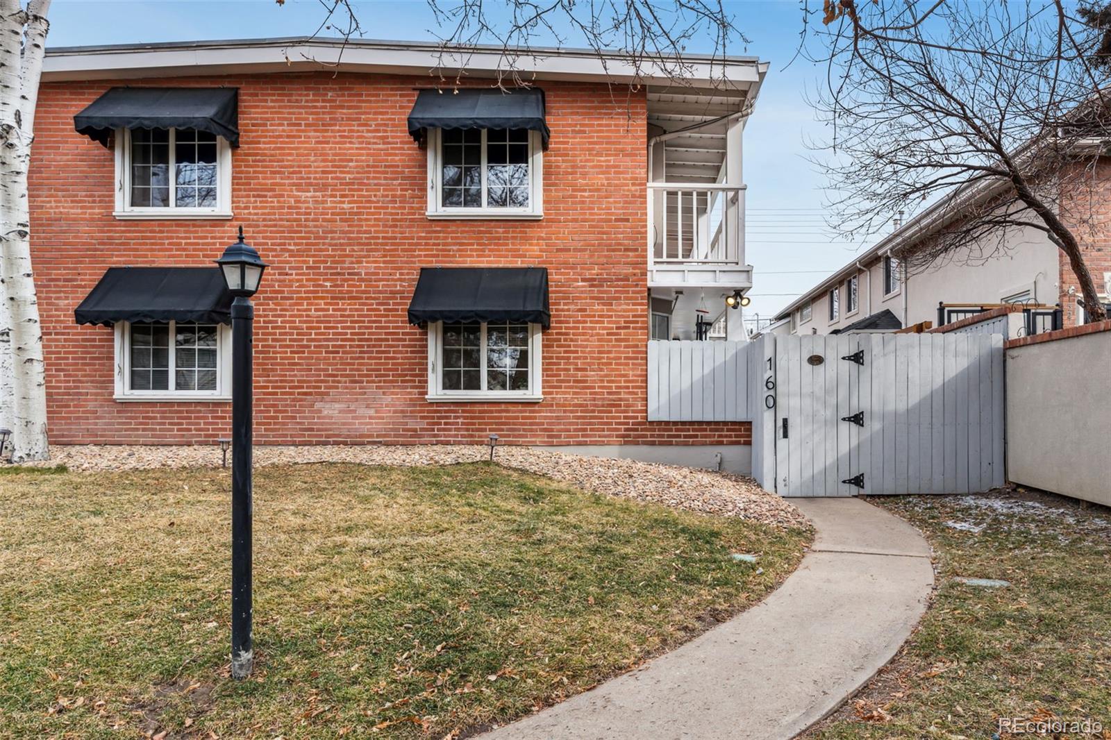 160 Jackson Street, Unit 5 Denver, CO 80206 - Photo 2 of 35 a front view of a house with a yard
