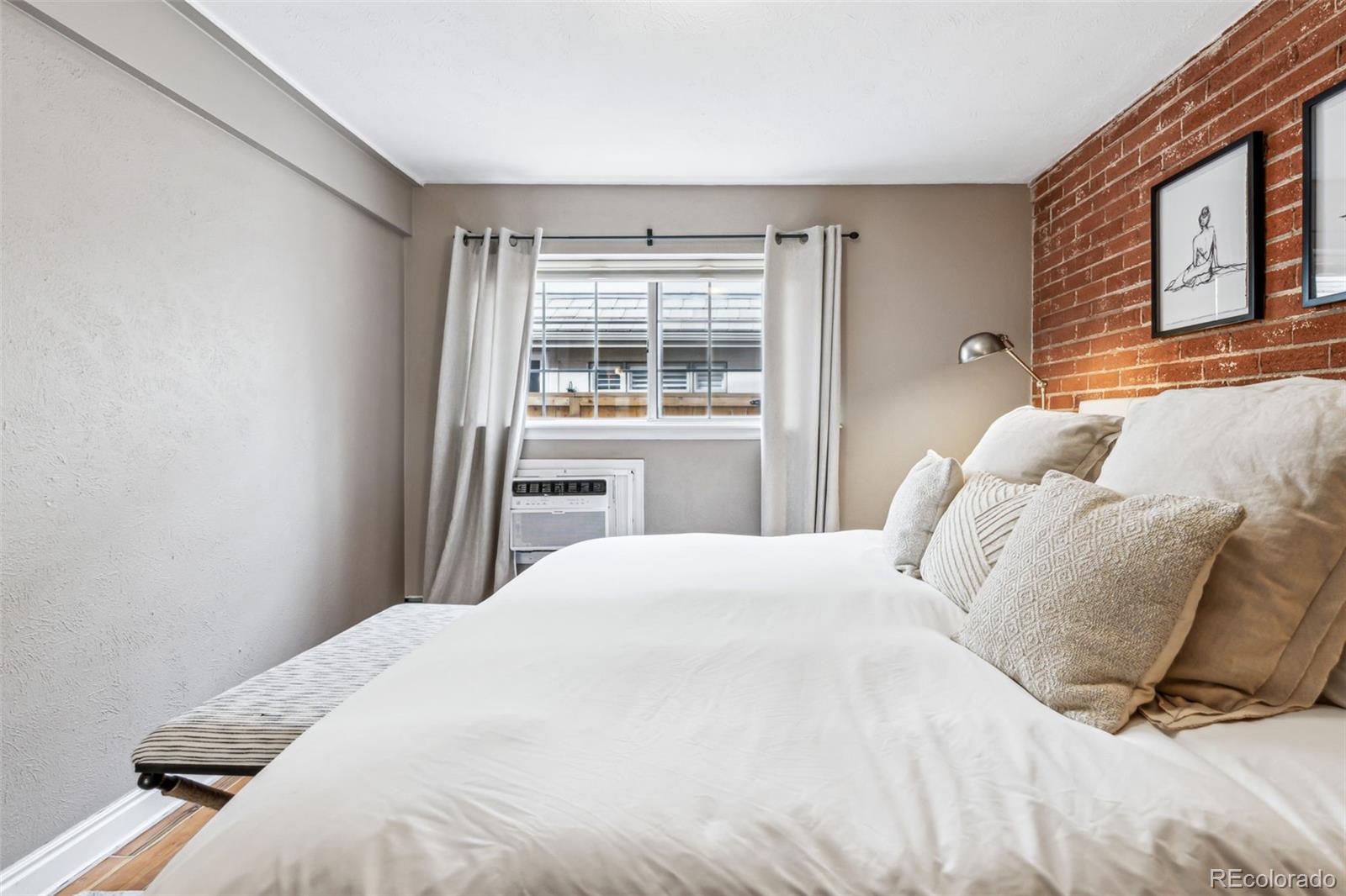 160 Jackson Street, Unit 5 Denver, CO 80206 - Photo 21 of 35 a bedroom with a bed and a window