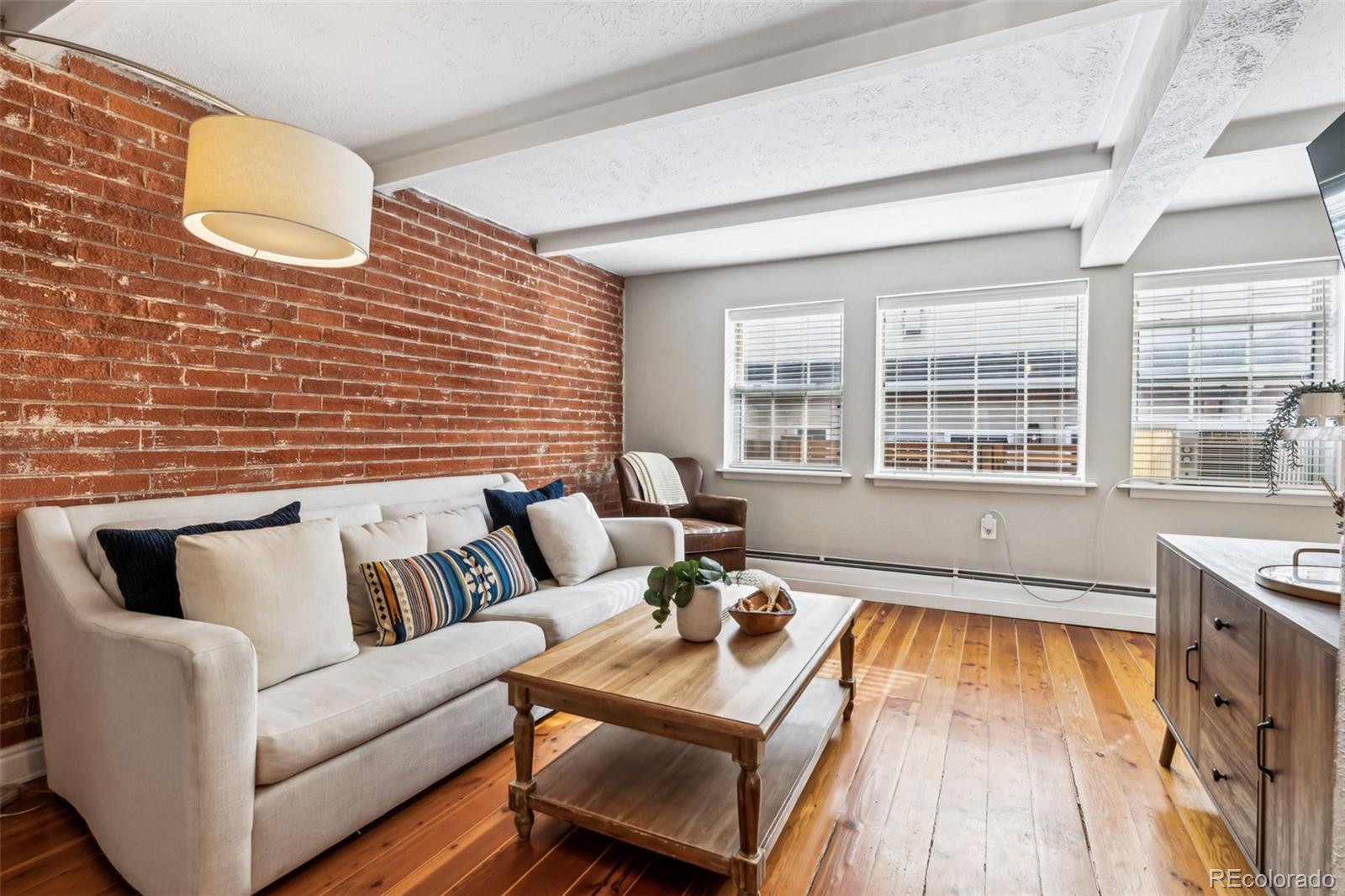 160 Jackson Street, Unit 5 Denver, CO 80206 - Photo 3 of 35 a living room with furniture and a floor to ceiling window