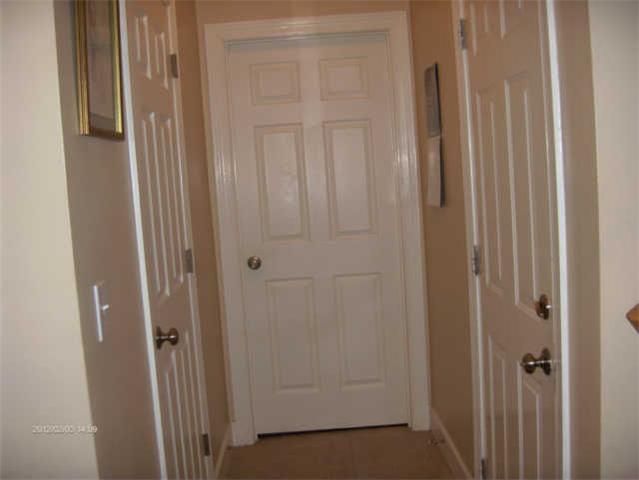 115 Conquest Road Murfreesboro, TN 37128 - Photo 16 of 17 Hallway downstairs...the door to the right leads to the garage...the door in front is the utility room and the door to the left is the half bath.