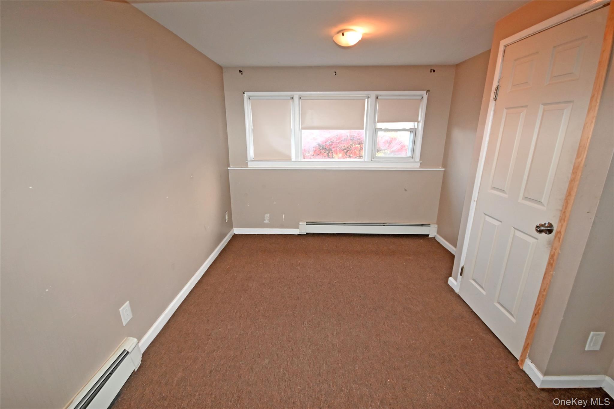 89 Osborne Road West Hempstead, NY 11552 - Photo 44 of 50 Unfurnished bedroom with baseboard heating and carpet