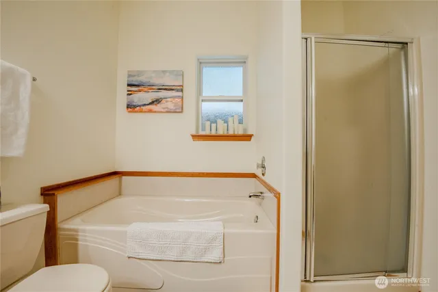 a bathroom with a tub and toilet