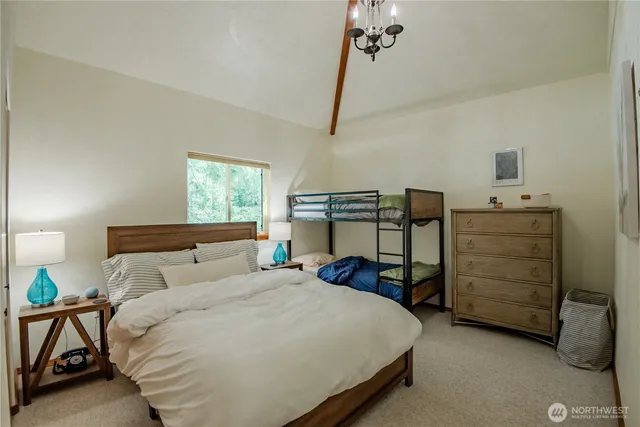 a bedroom with a bed and a table