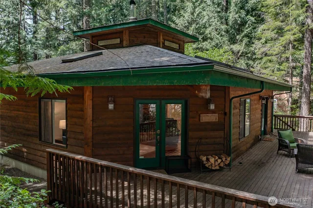 a view of a wooden house with a small yard