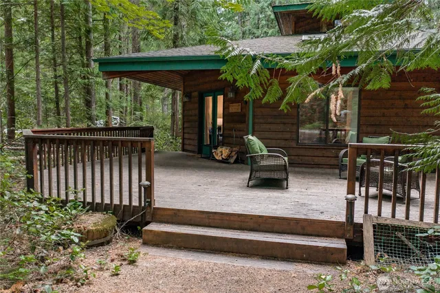 a backyard of a house with barbeque oven table and chairs