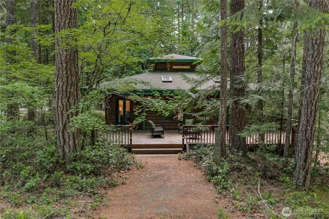 a front view of a house with a tree