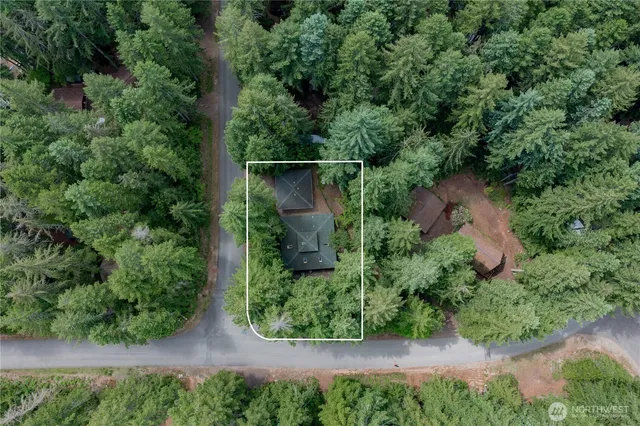 an aerial view of a house with a yard
