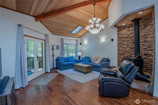 a living room with furniture a chandelier and a large window