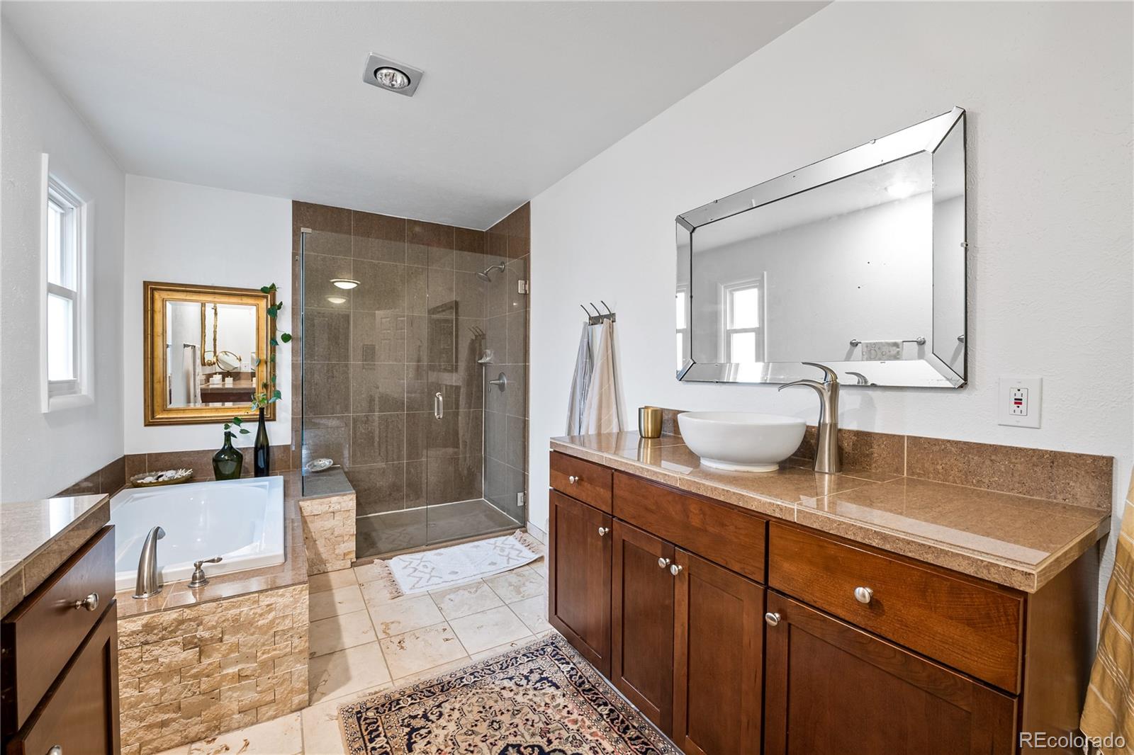 3385 Braun Road Golden, CO 80401 - Photo 17 of 40 a spacious bathroom with a granite countertop sink mirror and shower