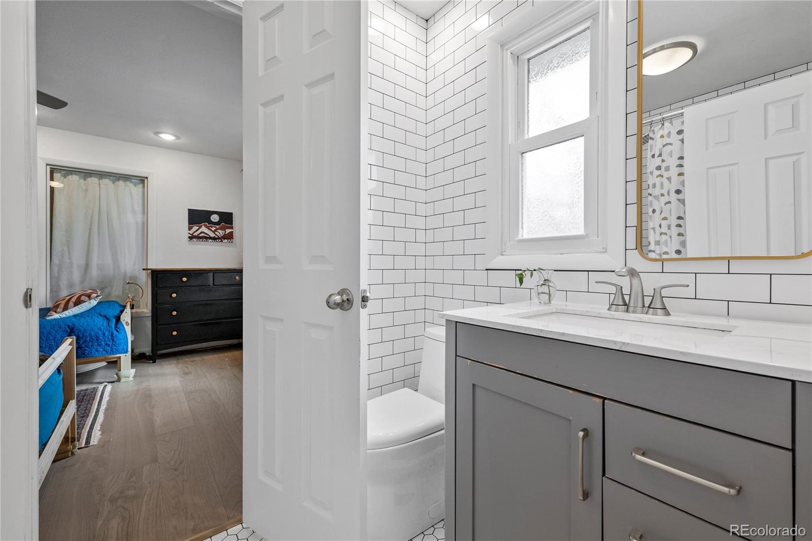 3385 Braun Road Golden, CO 80401 - Photo 24 of 40 a en suite bathroom with a granite countertop sink mirror and a toilet