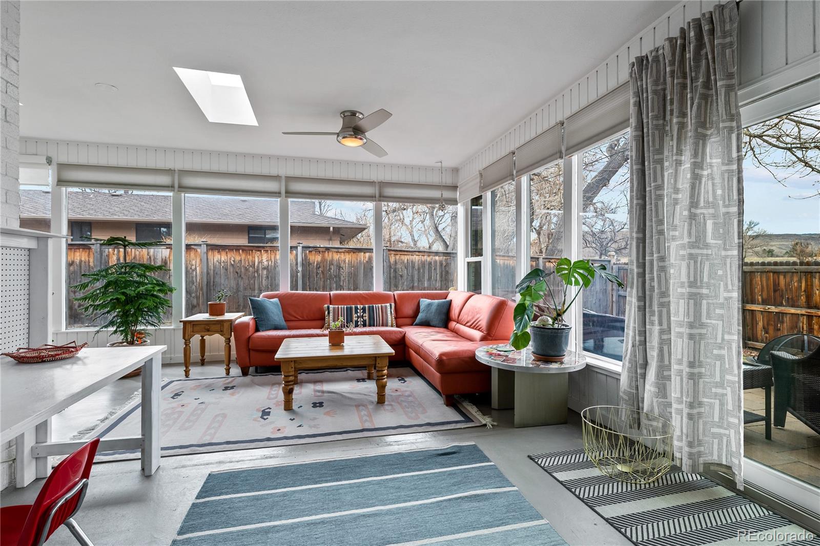 3385 Braun Road Golden, CO 80401 - Photo 30 of 40 a living room with patio furniture and a potted plants next to a large window