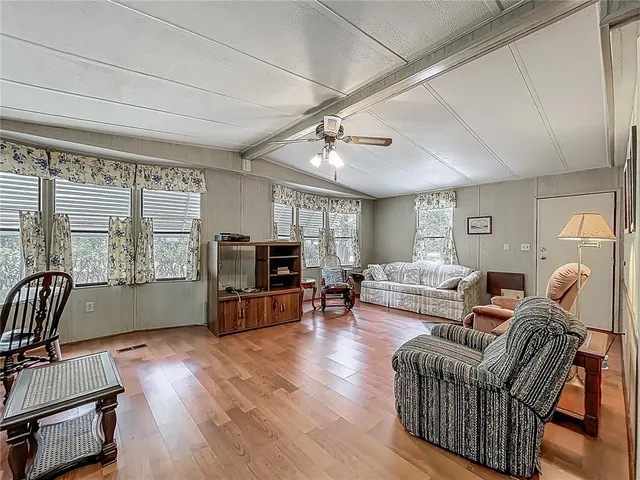 a living room with furniture fireplace and a flat screen tv