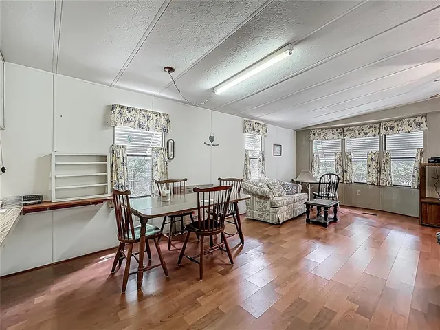 a view of a dining room with furniture and wooden floor
