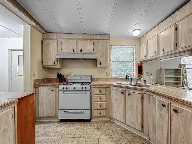 a kitchen with stainless steel appliances granite countertop a sink and cabinets