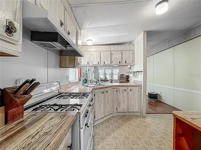 a kitchen with a stove a sink and a refrigerator