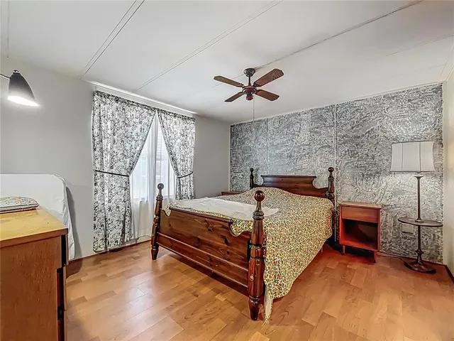 a bed sitting in a room next to a larger window