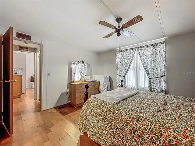 a bedroom with a bed and a large window