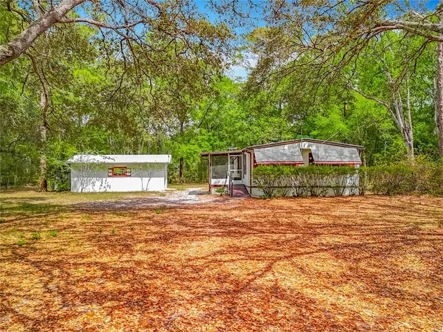 a front view of a house with a yard and mountain view