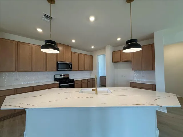 a bathroom with a sink a large mirror and vanity