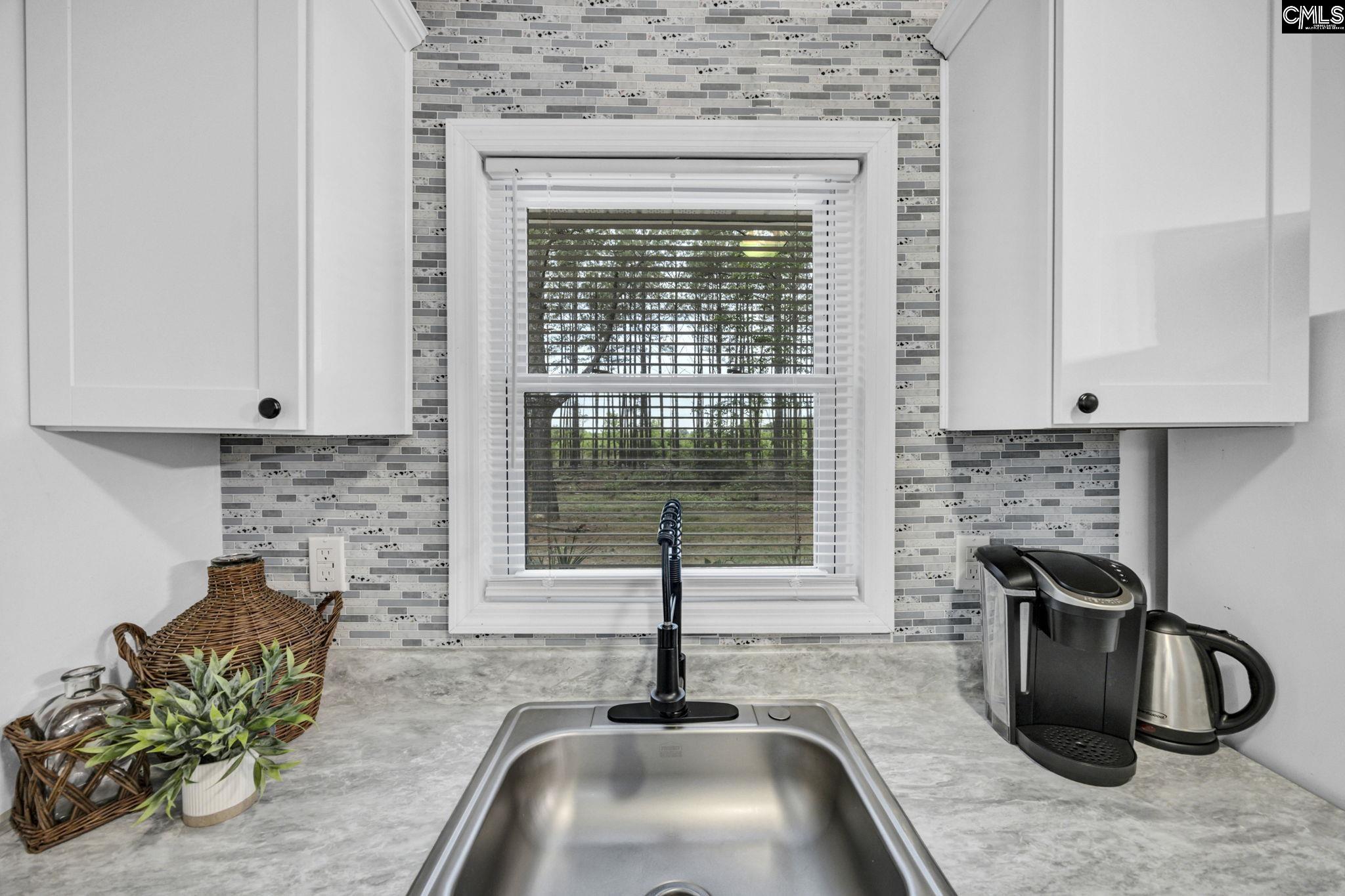 8107 Black River Road Rembert, SC 29128 - Photo 11 of 38 a kitchen with a sink and a window
