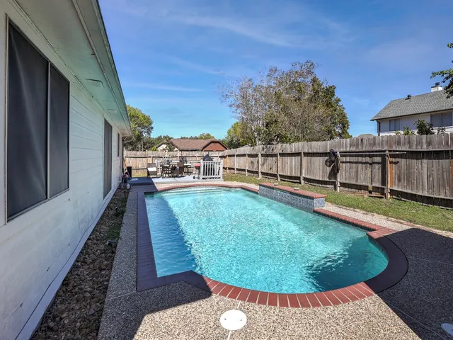 a view of a swimming pool with a patio