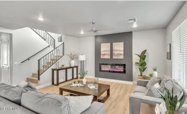 a living room with furniture and wooden floor