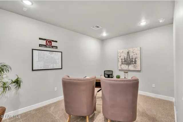 a workspace with furniture and wall paintings