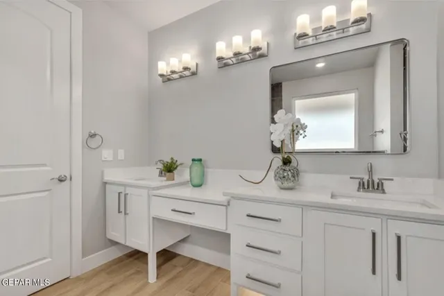 a bathroom with a double vanity sink and a mirror
