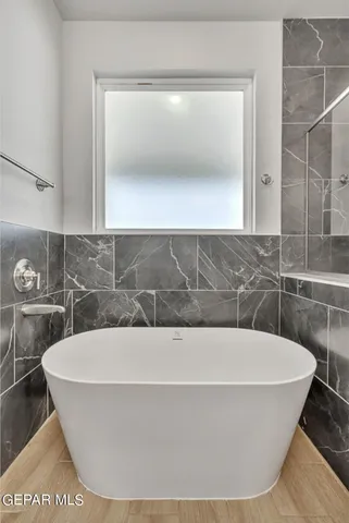 a white bath tub sitting in a bathroom
