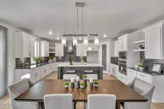 a large kitchen with a table and chairs