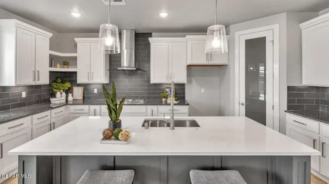 a kitchen with a table and chairs