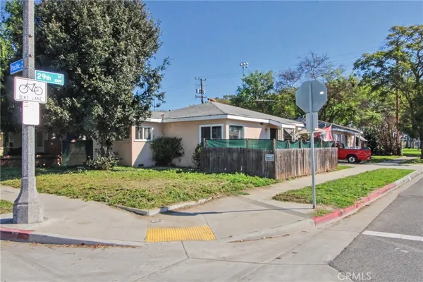 a front view of a house with a yard and potted plants