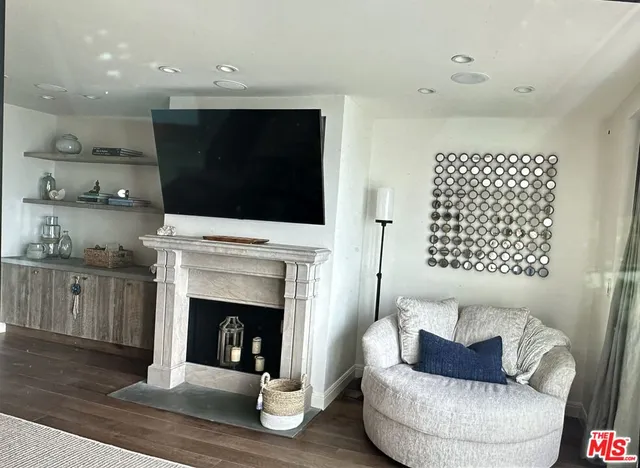 a living room with furniture a fireplace and a flat screen tv