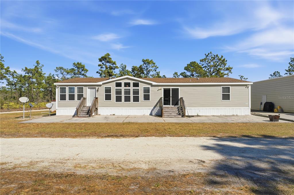 6844 Chad Jason Road St. Cloud, FL 34773 - Photo 46 of 59 a view of a house with swimming pool and sitting area