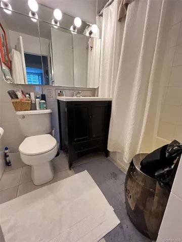 a bathroom with a toilet and a mirror