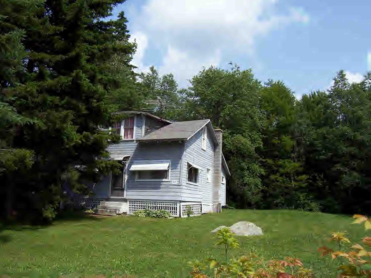 47 Access Windsor, MA 01270 - Photo 1 of 3 a front view of a house with a yard and trees