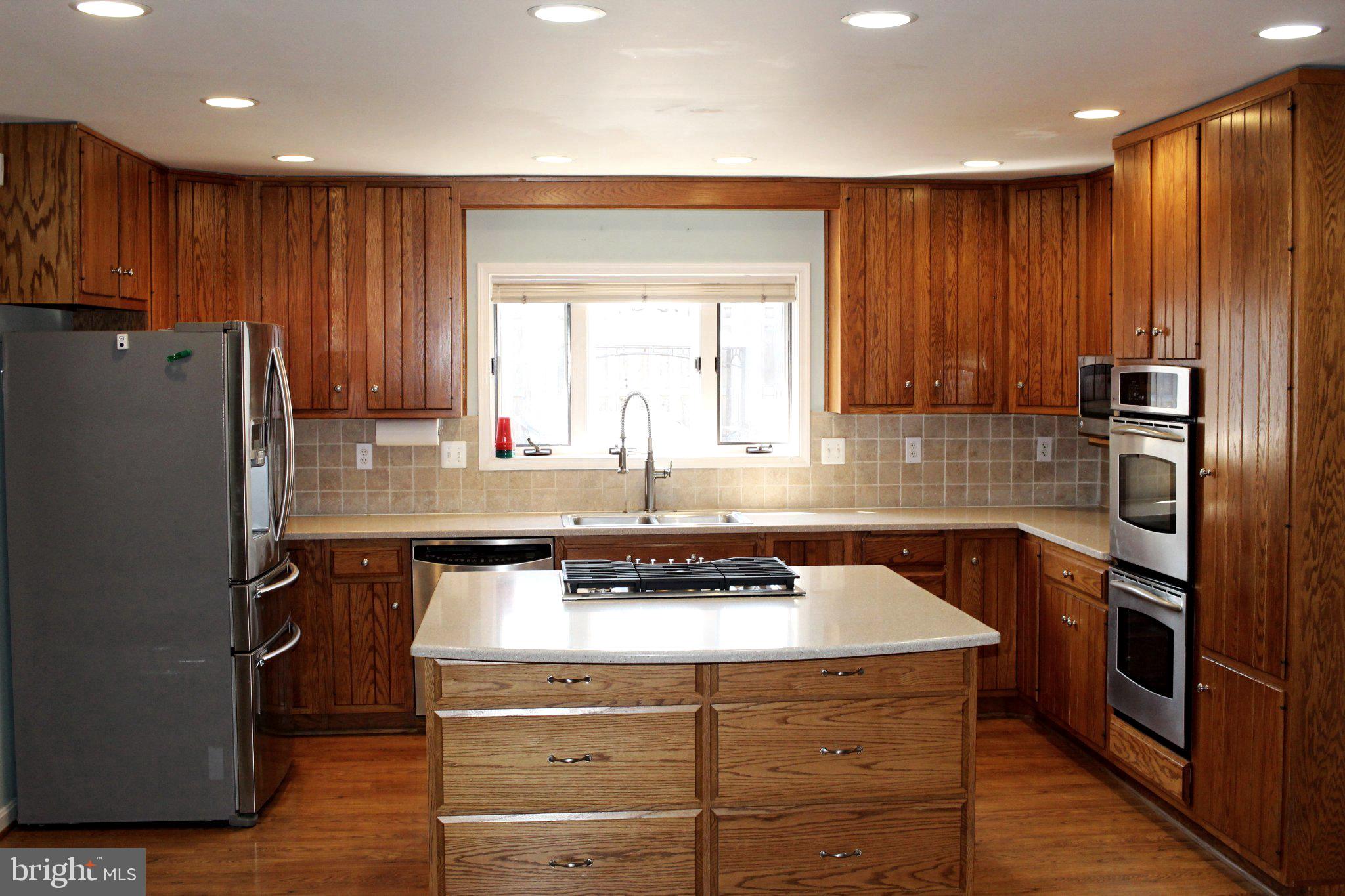 4511 Sudley Road Gainesville, VA 20155 - Photo 2 of 16 Warm wood tones in a spacious kitchen.